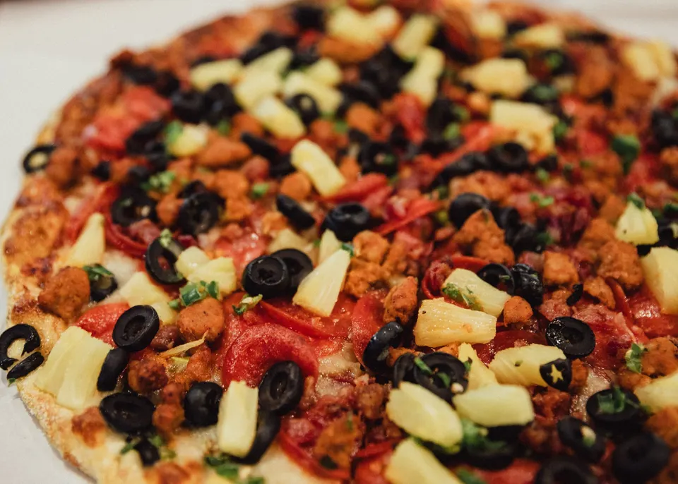 The Knight pizza: Hawaiian sauce, pepperoni, Italian sausage, bacon, black olives, pineapple, jalapenos & mozzarella
