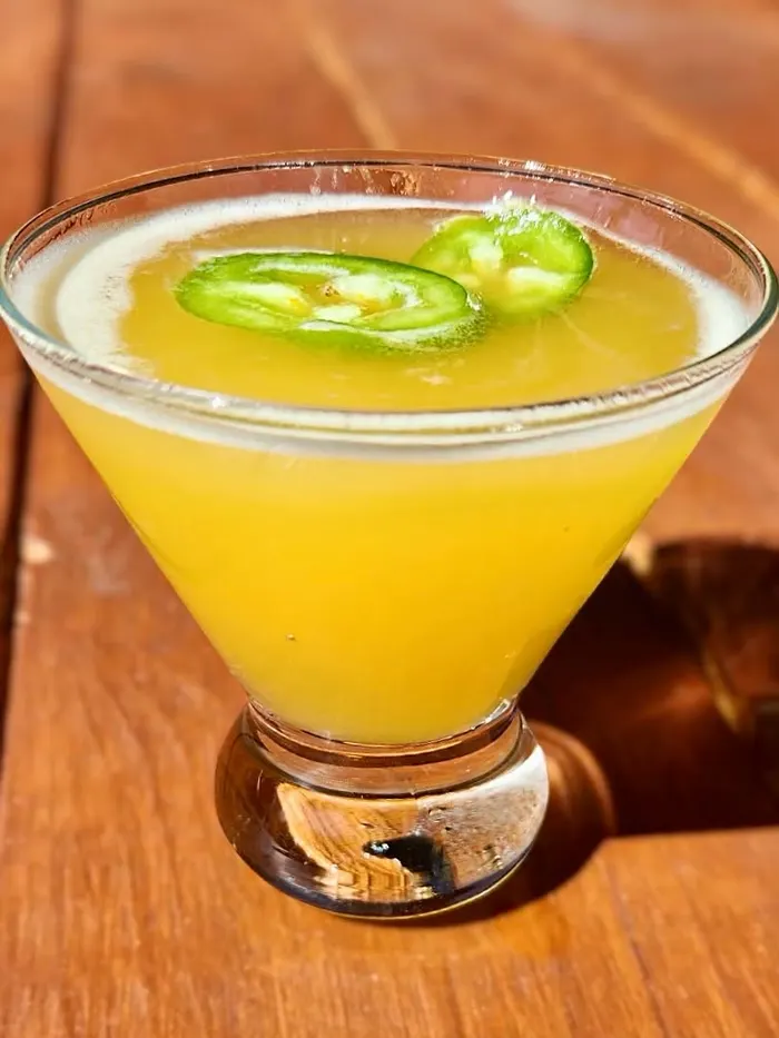 A margarita garnished with jalapeño slices