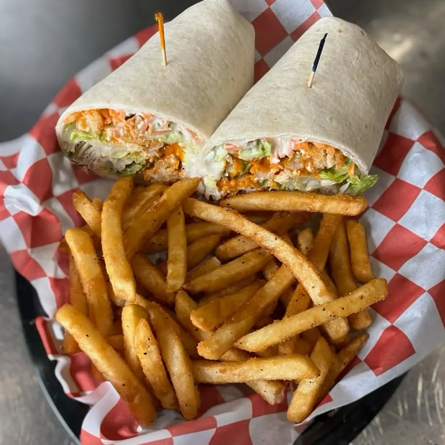A wrap with fries in a red-checked basket