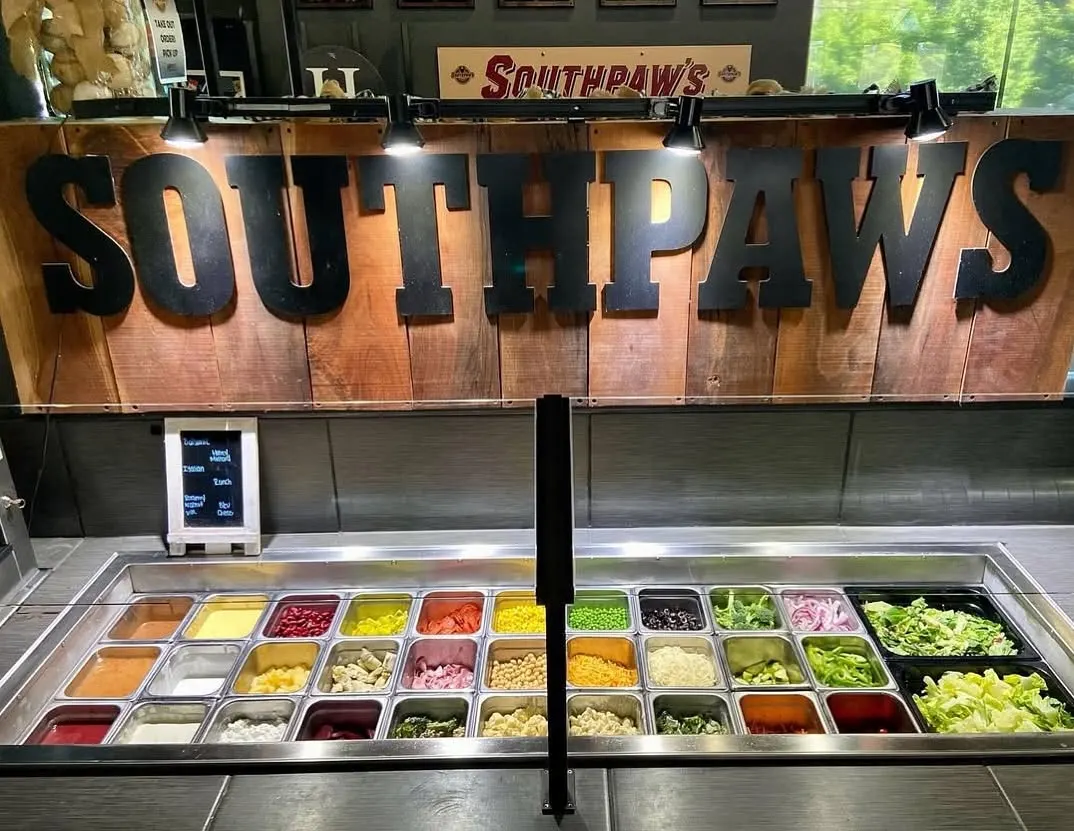 The salad bar under a big carved wooden SOUTHPAWS sign